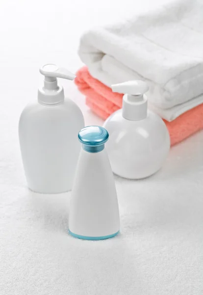 Tre flaskor med två handdukar — Stockfoto