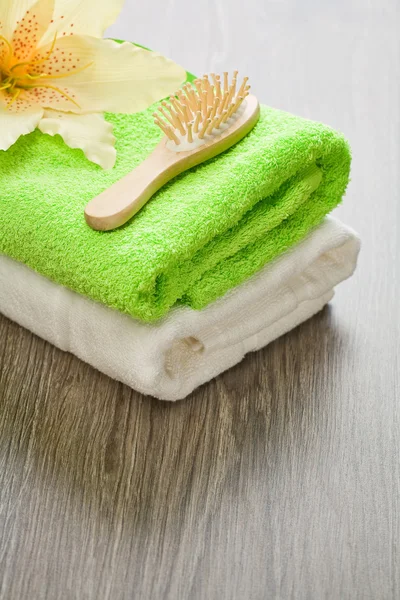 Bloem op handdoeken met haarborstel — Stockfoto