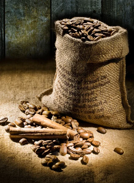 Sack of coffee beans on a background of old boards — Stock Photo, Image