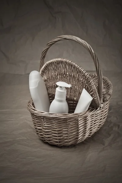 Basket with bottles and tube — Stock Photo, Image