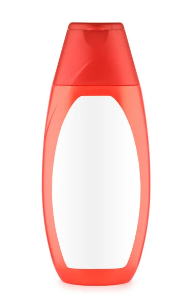 Красная бутылка с белой этикеткой — стоковое фото