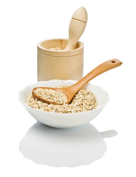 Cereals in dish with spoon and mortar — Stock Photo, Image