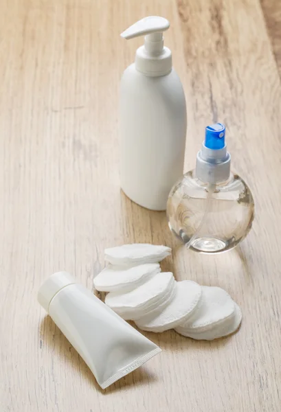 Cotton pads tube and bottles — Stock Photo, Image