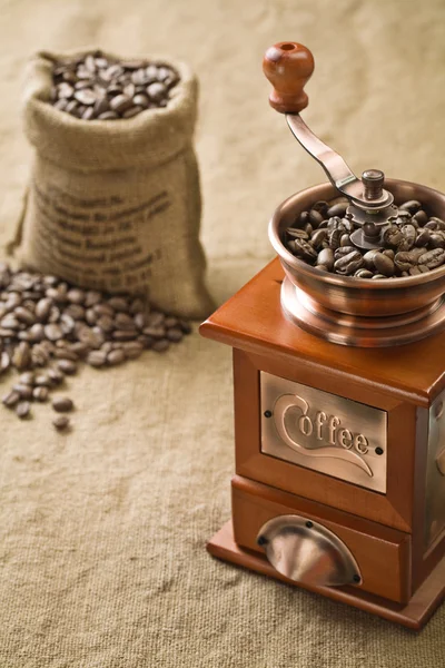 Coffee beans in bag and coffee grinder — Stock Photo, Image