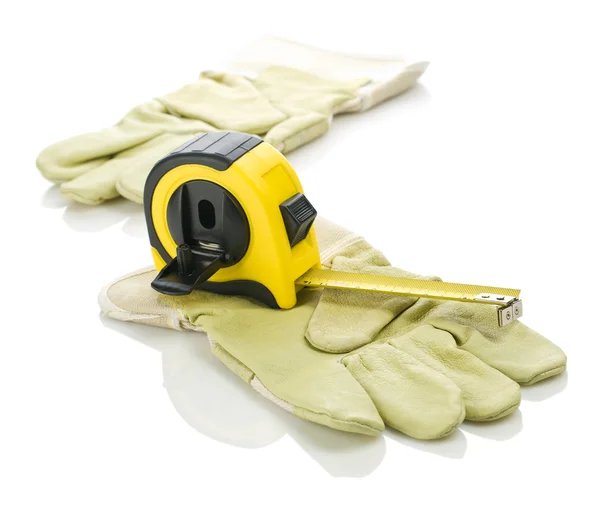 Handschoenen met gele rolmaat — Stockfoto