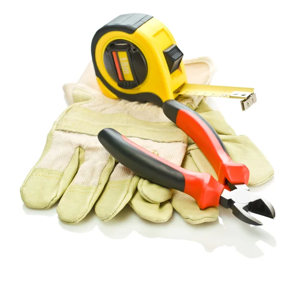 Gloves with tapeline and pliers — Stock Photo, Image