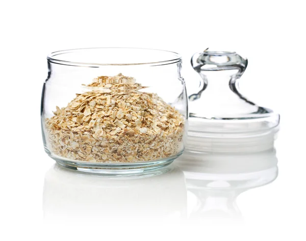 Open glass jar with cereals — Stock Photo, Image