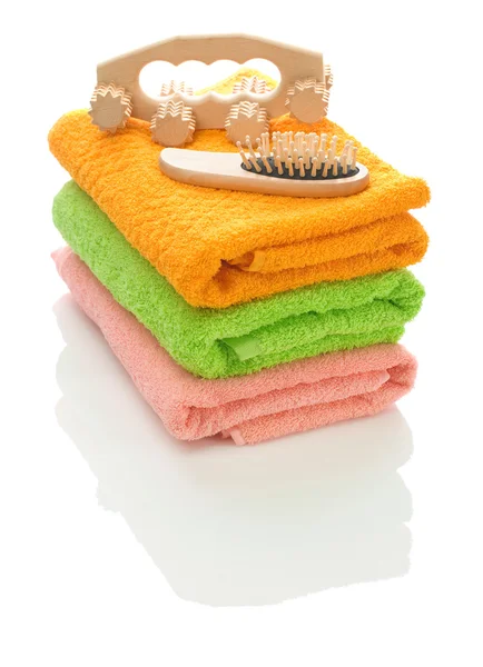 Massager and hairbrush on towels — Stock Photo, Image