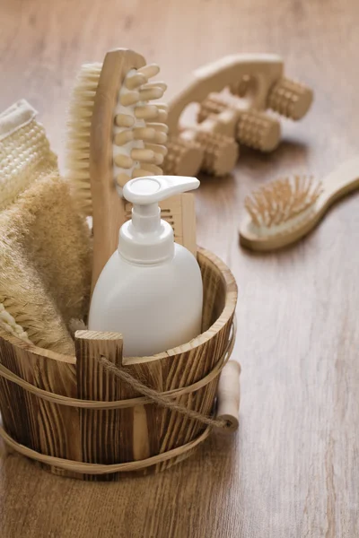Hairbrush massager and wooden bucket — Stock Photo, Image