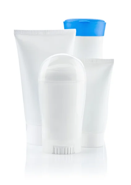 Garrafa branca redonda e dois tubos e garrafa com tampa azul — Fotografia de Stock