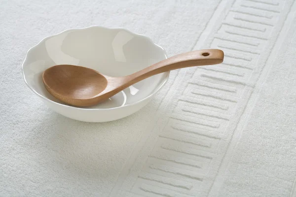 Wooden spoon in bowl — Stock Photo, Image