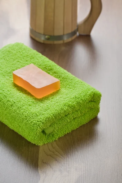 Soap on towel with mug — Stock Photo, Image