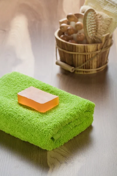 Soap on towel with wooden bucket — Stock Photo, Image