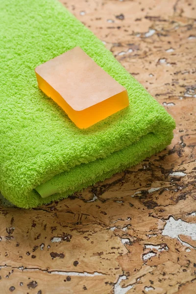 Soap and towel on cork wood — Stock Photo, Image