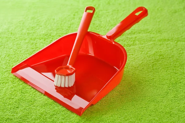Red dustpan with brush — Stock Photo, Image