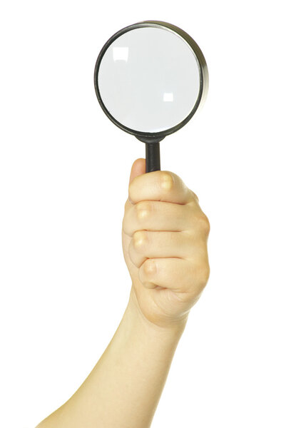 Hand holding a magnifying glass on white