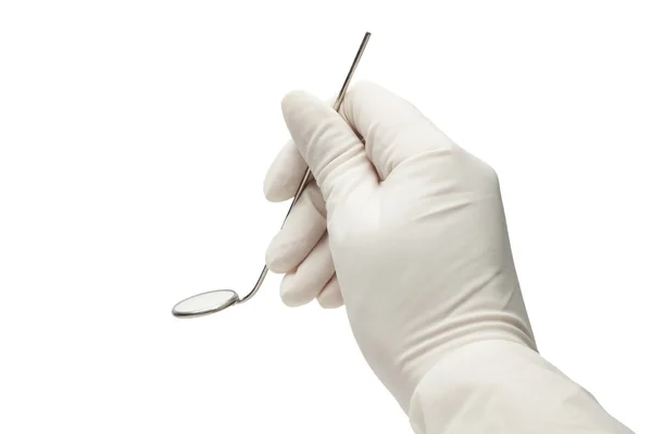 Ręka trzyma lustro na białym tle nad białym. badania u dentysty — Zdjęcie stockowe