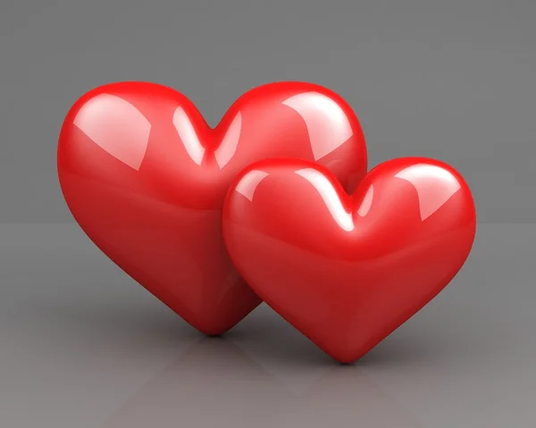 Két piros szív, a szürke háttér — Stock Fotó