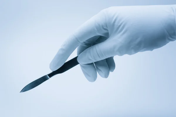 Hand Of Surgeon With Scalpel During Surgery Stock Photo Garloon