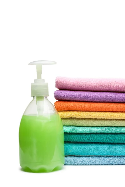 Colorful towels and liquid soap isolated over white background — Stock Photo, Image