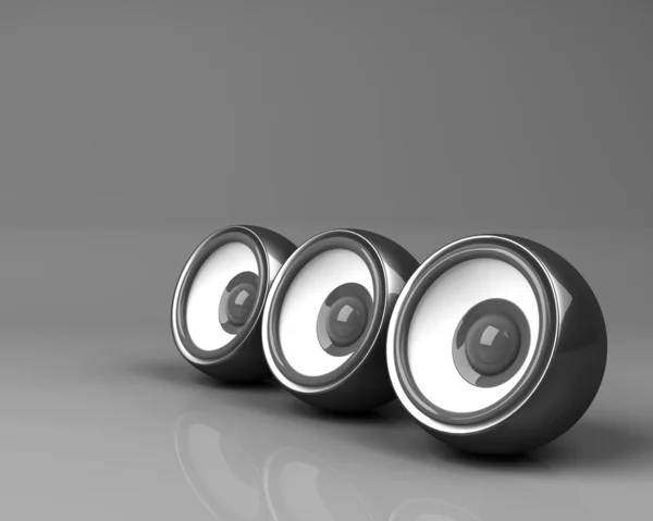 Three black speakers on the grey background — Stock Photo, Image