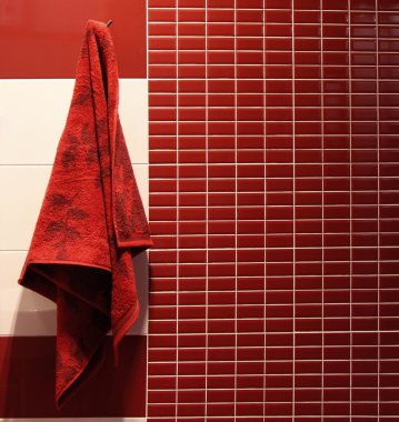 Red towel hangs in a bathroom clipart