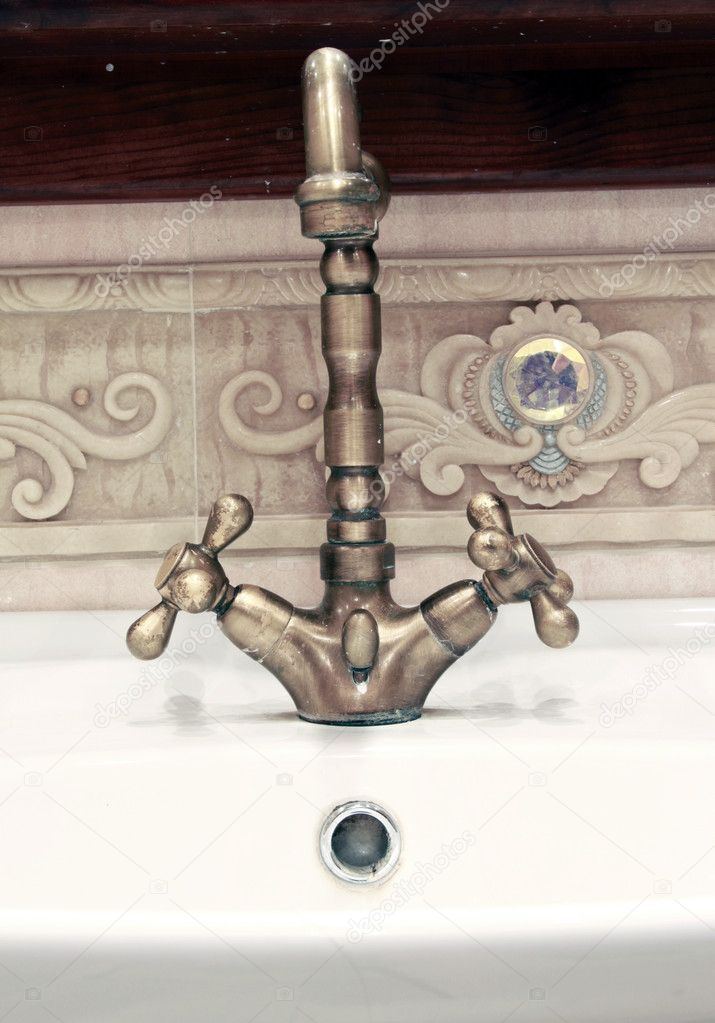 Closeup detail to a retro style bronze water tap
