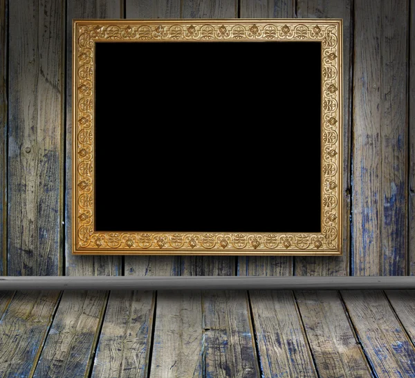 Wooden grunge interior with antique picture frame — Stock Photo, Image