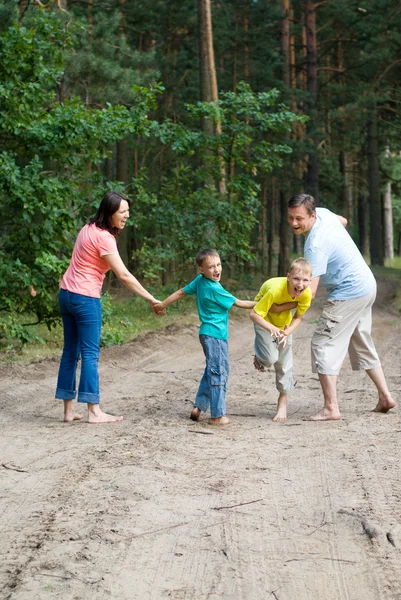 Family of four walking — Stock Photo, Image