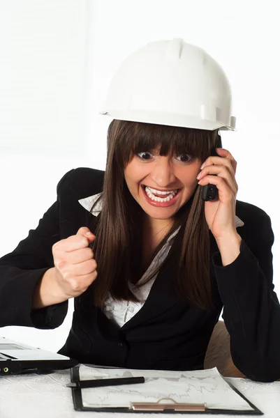 Girl sitting in the construction helmet — Stock Photo, Image