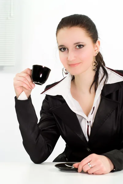 Woman drink in a black business suit — Stock Photo, Image