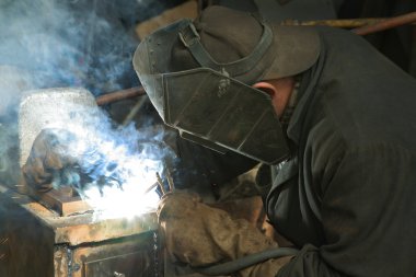 Worker is engaged in welding clipart