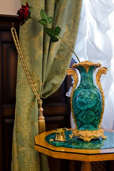 Antiquarian vase at a window — Stock Photo, Image