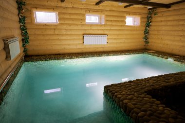 Beautiful and deep pool in a wooden sauna clipart