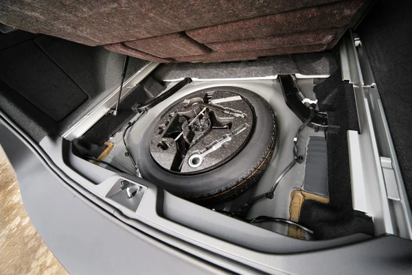 stock image Spare wheel in a luggage carrier of the modern car