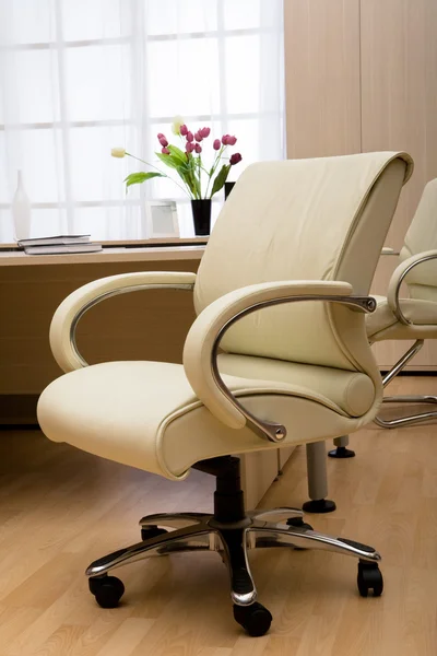 stock image Modern leather armchair on a background of a window