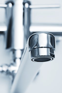 Beautiful close-up faucet in the modern bathroom clipart