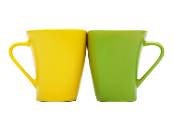 在白色背景上的黄色和绿色马克杯 — 图库照片