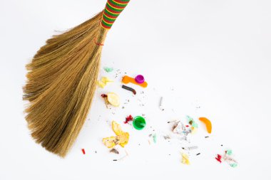 Broom sweeping various debris clipart