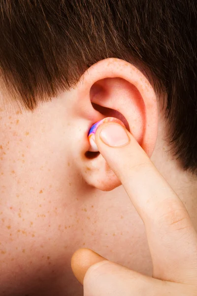 Earplug into the ear — Stock Photo, Image