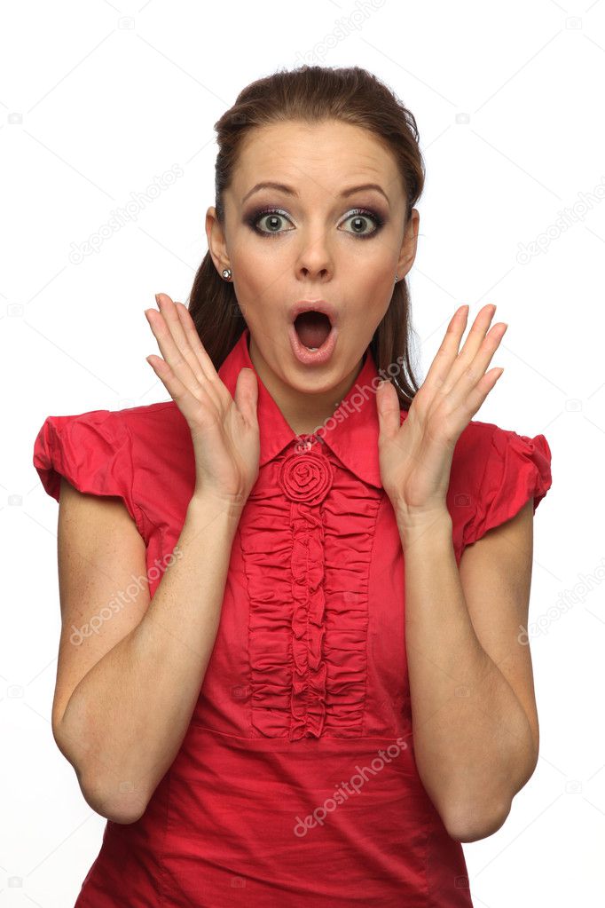 Pretty girl in a red blouse very surprised (white background)