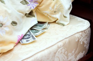 Money tucked away under a pillow clipart