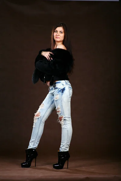 Attracive Young Woman Fur Coat Jeans Browm Background — Stock Fotó