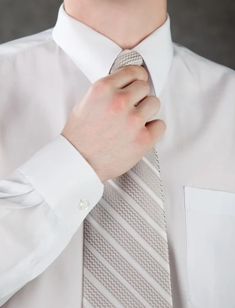 stock image Businessman is adjusting his tie