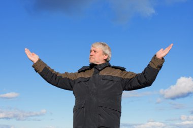 Middle-aged man on blue sky of the background. clipart