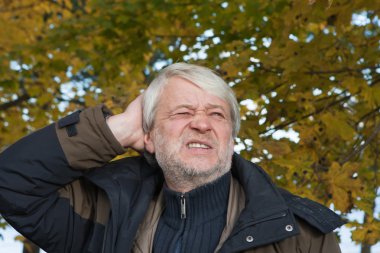 Portrait of middle-aged man in autumn day. clipart