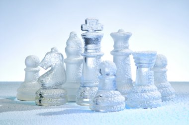 Glass chess figures, covered snow clipart