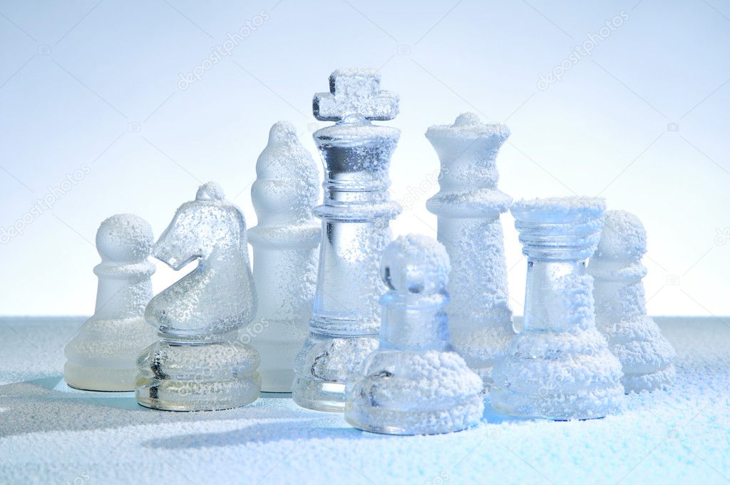 Glass chess figures, covered snow