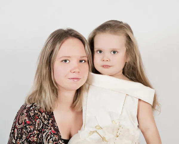 stock image Beautiful young mother and her three year old daughter at studio