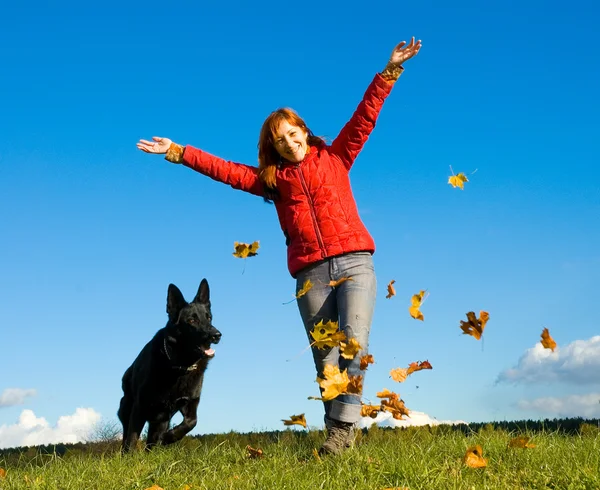 Woman with a big black dog — Stock Photo, Image